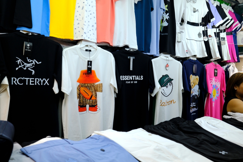 Counterfeit clothing being sold in a market. Credit, Go Dong Photo, Shutterstock