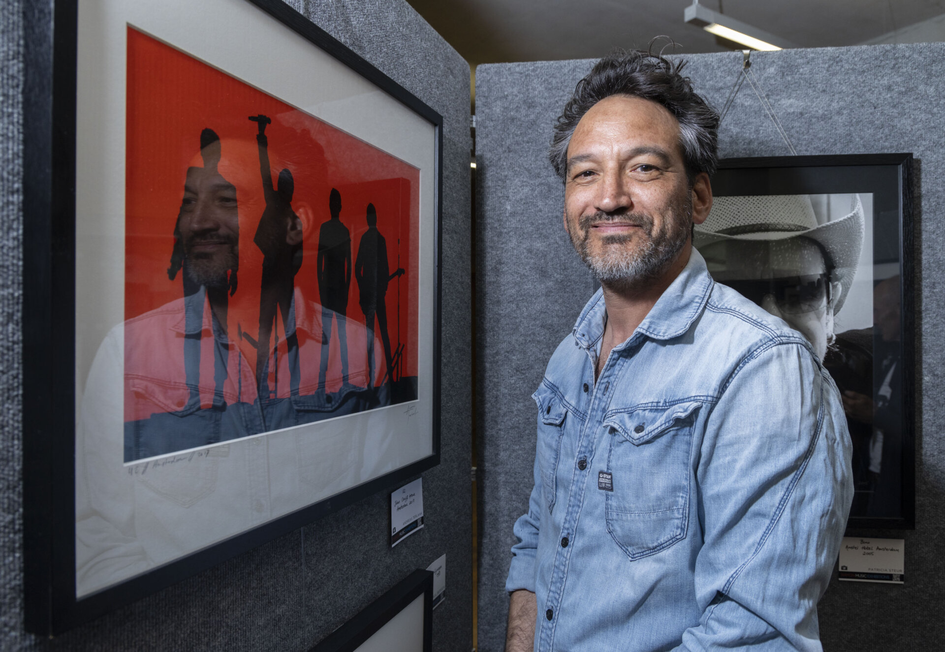 Pictured: Andreas Terlaak with his picture of U2. Dlr lexicon exhibition opening - 50 Years of Irish Rock Through the Lens of Dutch. Photo credit: Paul Sherwood for Coalesce 2026