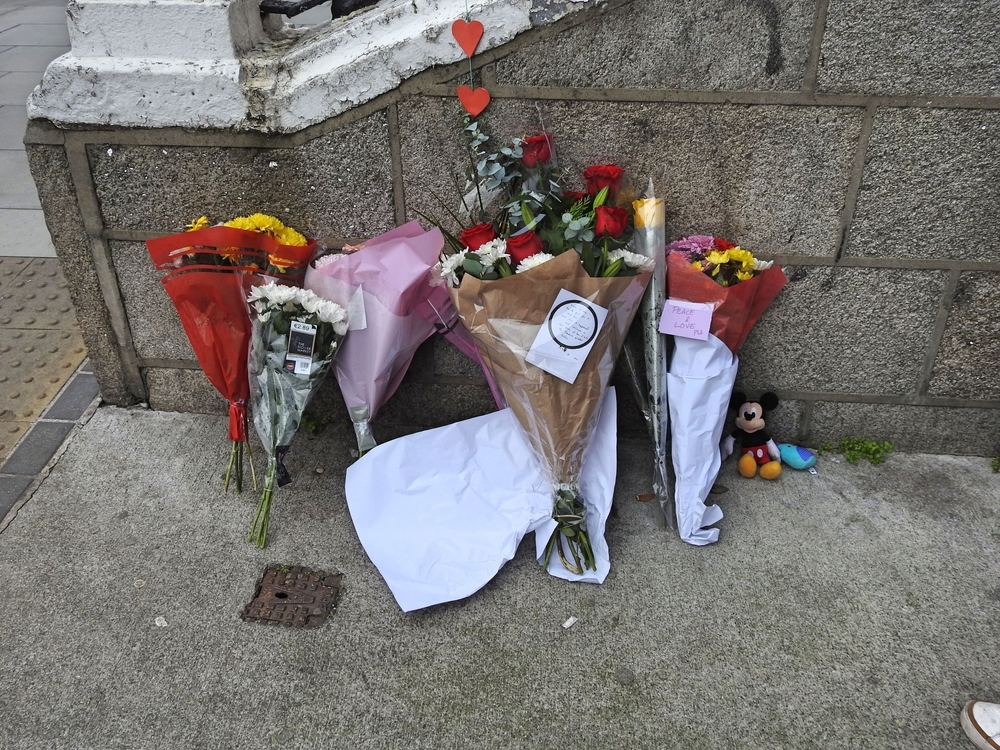 Flowers on Parnell Square near Gaelscoil Colaiste Mhuire, where there was an attack on the school's children on 23rd November. Derick P. Hudson, Shutterstock